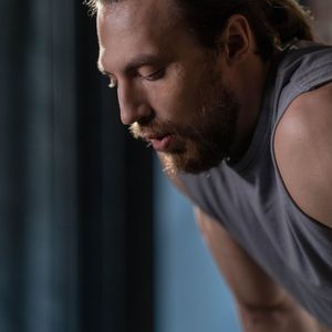 Close-up of a man's focused face during exercise.